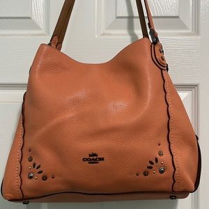 Coach purse, handbag style with 3 compartments. Middle compartment with zipper.